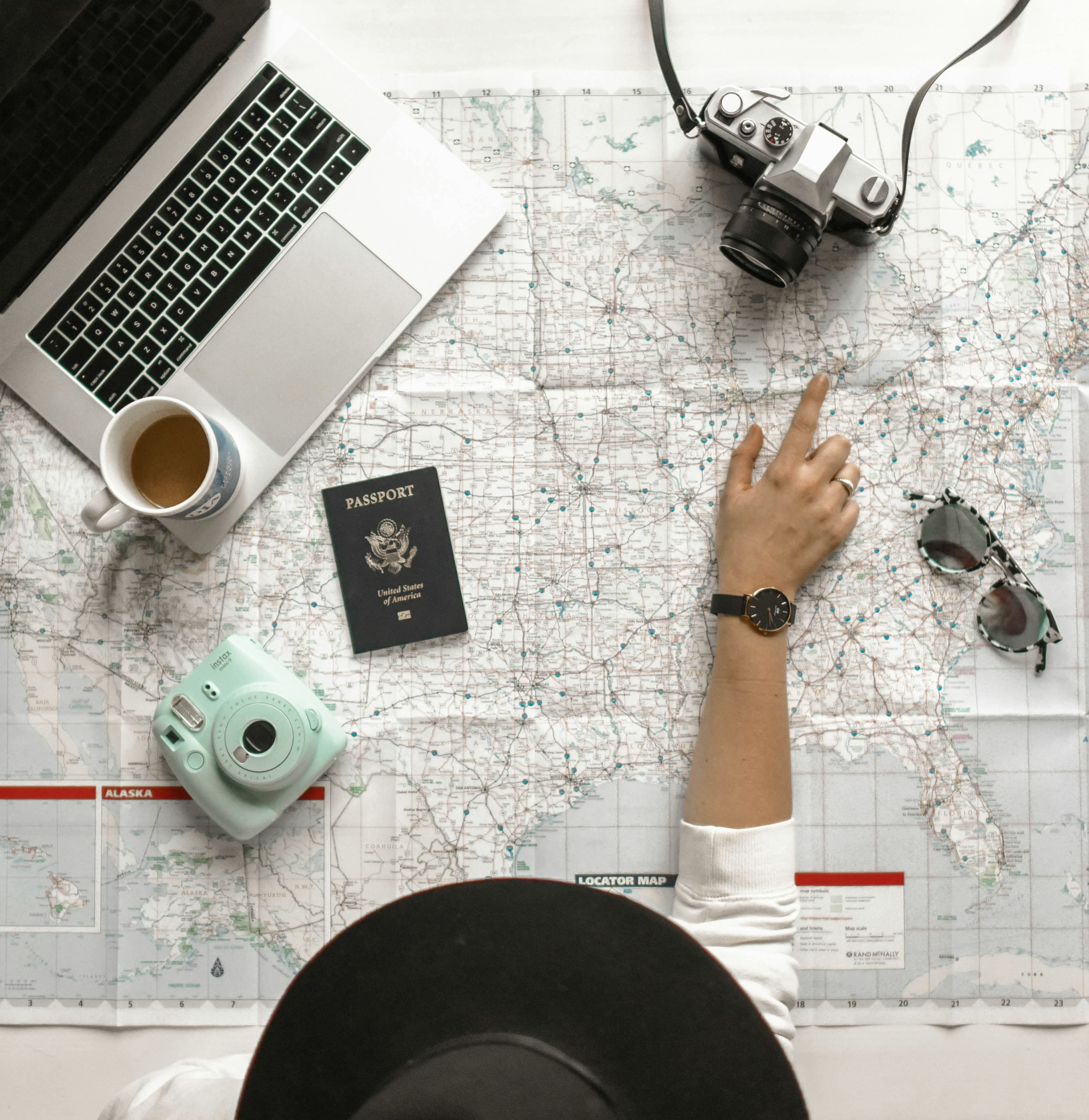 Passport, laptop and travel map for immigration planning